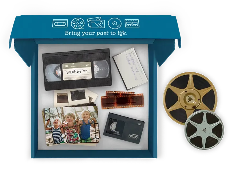 Forever digitization box containing VHS tapes, film reels, slides, and vintage photos
